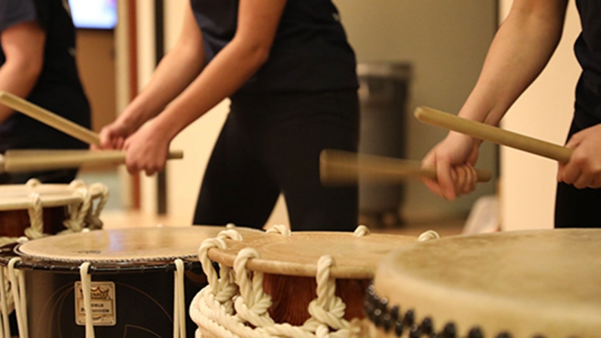 Students play Japanese drums.