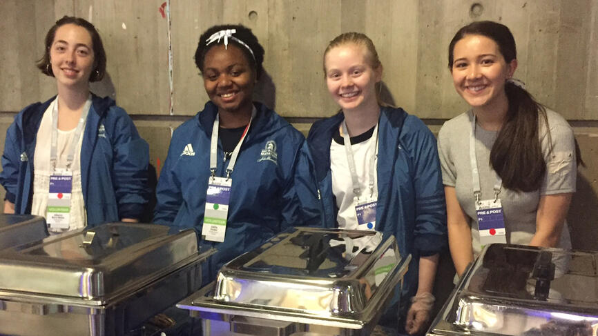 Student volunteers preparing to serve runners