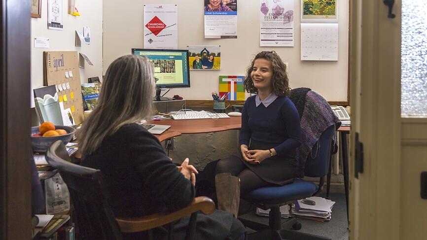 A student sits in a meeting with a faculty member