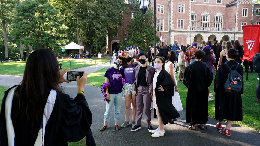 people pose for photos outside of convocation