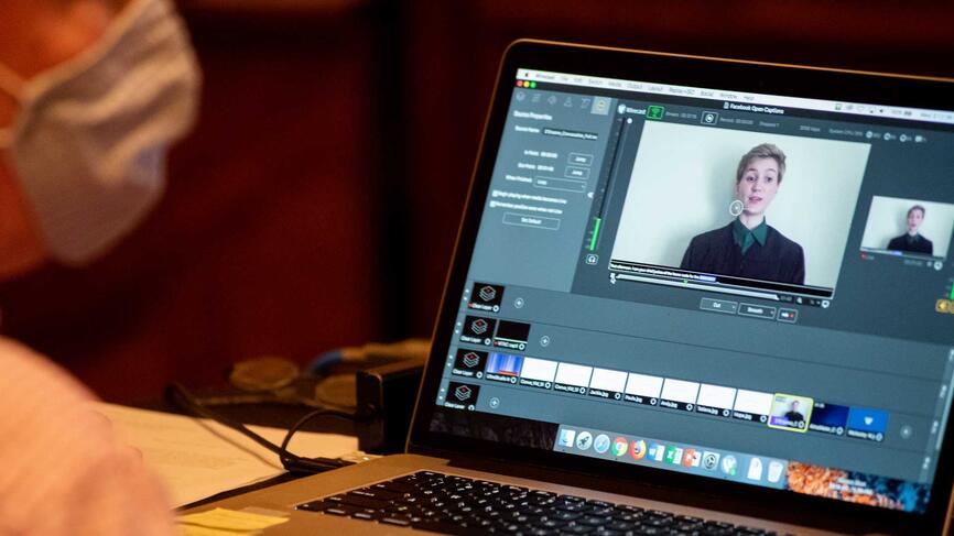 a laptop showing a video of Hope D’Erasmo speaking