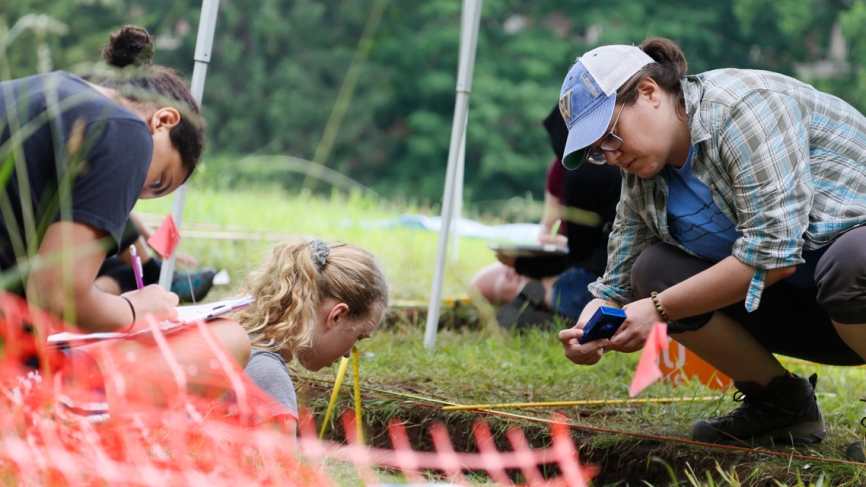 A visiting professor and students document their finds at a dig site on campus. 