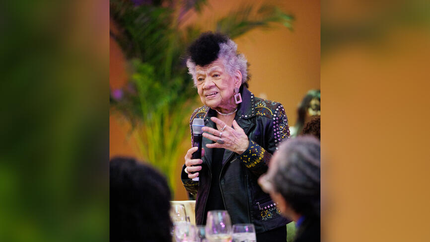 Lorraine O'Grady speaks to an audience during dinner.