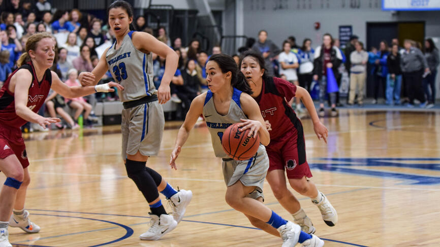 a student beats a defender on the basketball court.