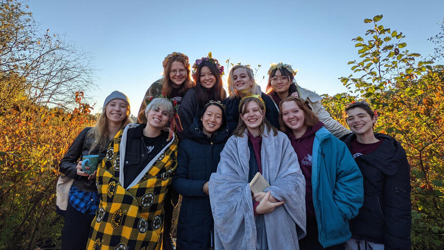 people posing as group on campus