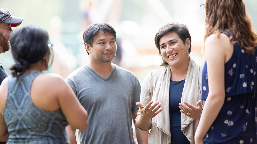 Emily Randall speaks to a group of individuals.