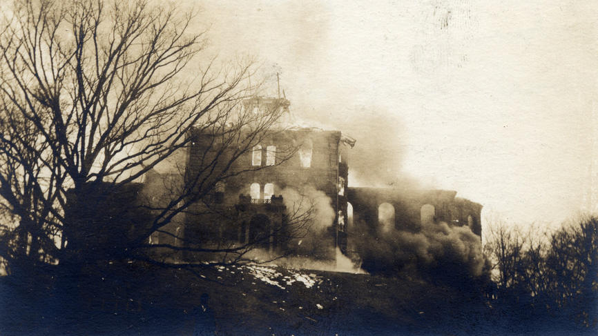 An archive photo showing the burning of College Hall in 1914. At left is the Severance Oak.