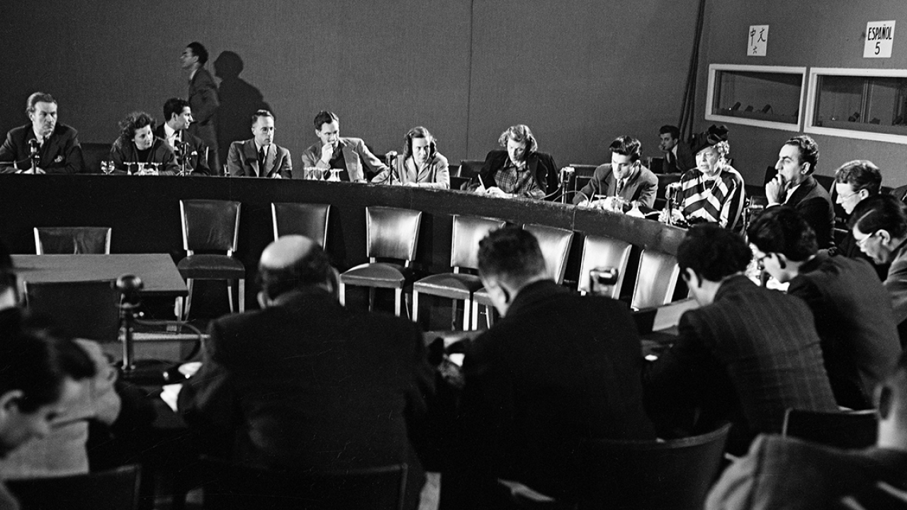 Eleanor Roosevelt and other leaders sit in conference after completing the Declaration of Human Rights.
