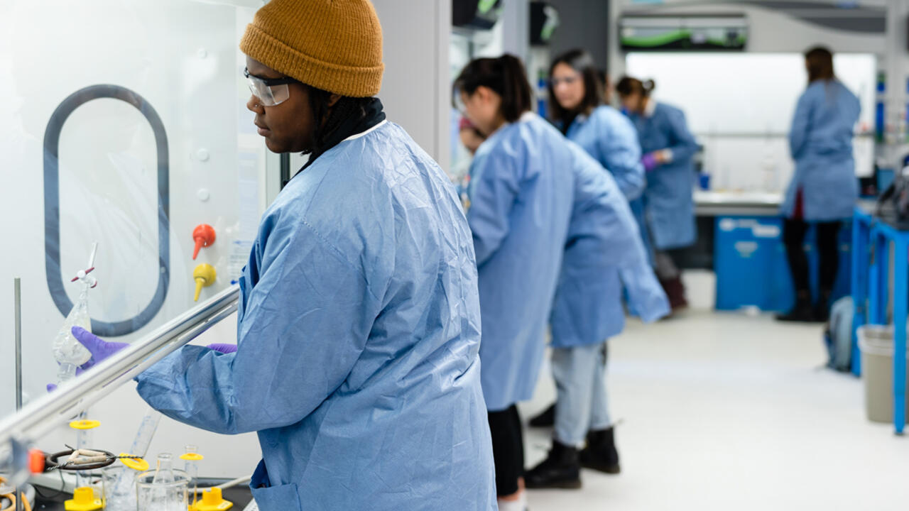 Students work under a hood in a lab at Wellesley. 