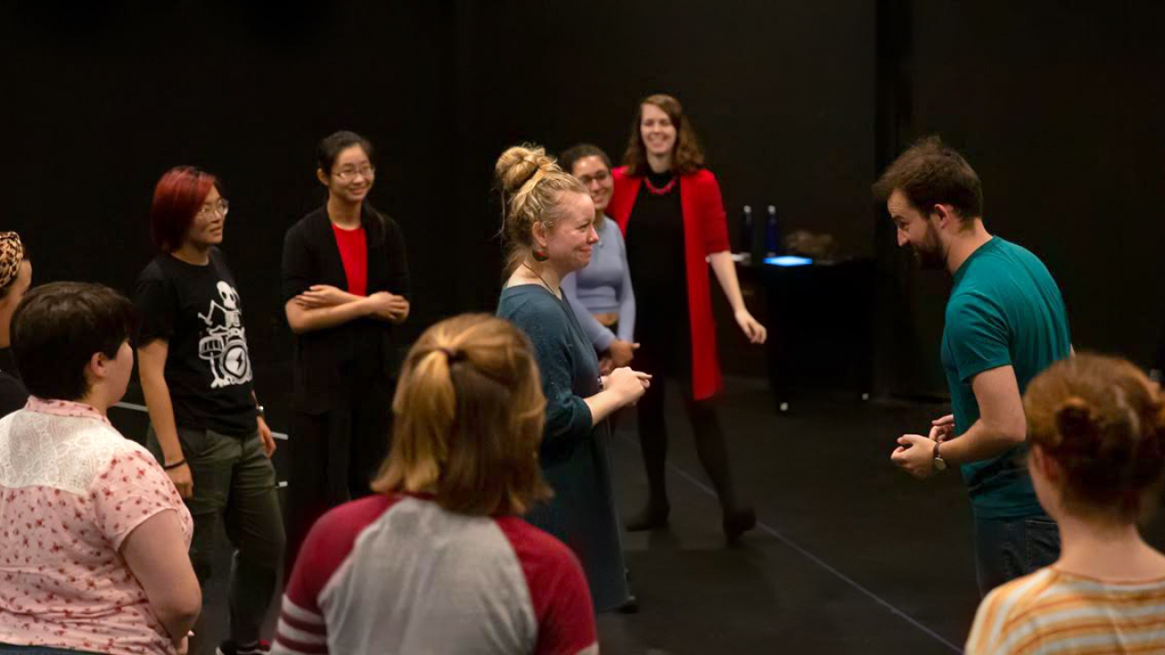 Students work with professional actors in a black box theatre