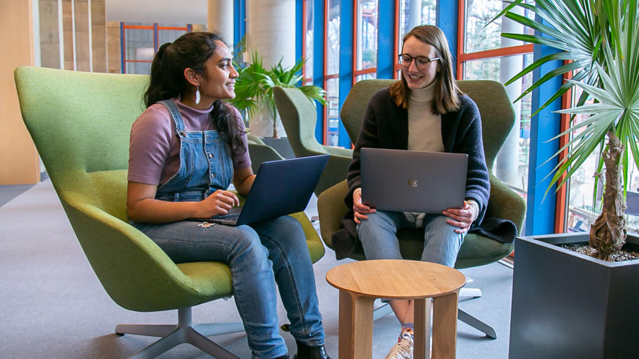Two students sit at a table in the science center.