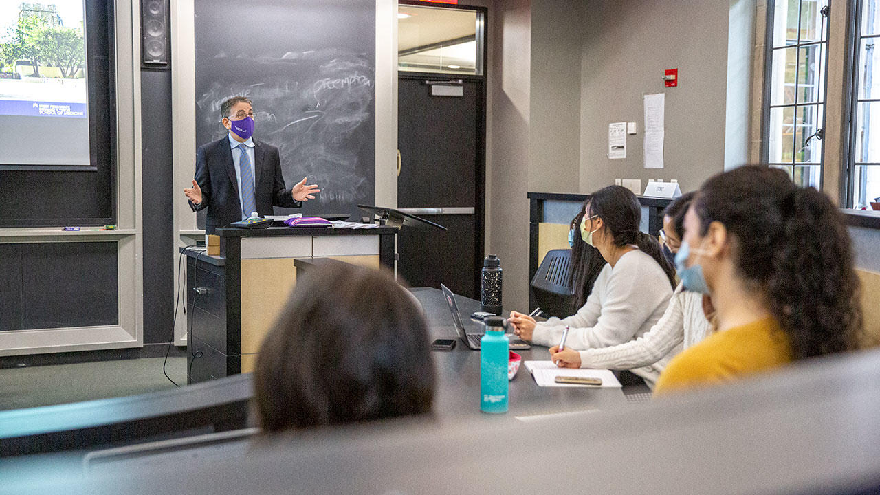 a person talking to a group of students