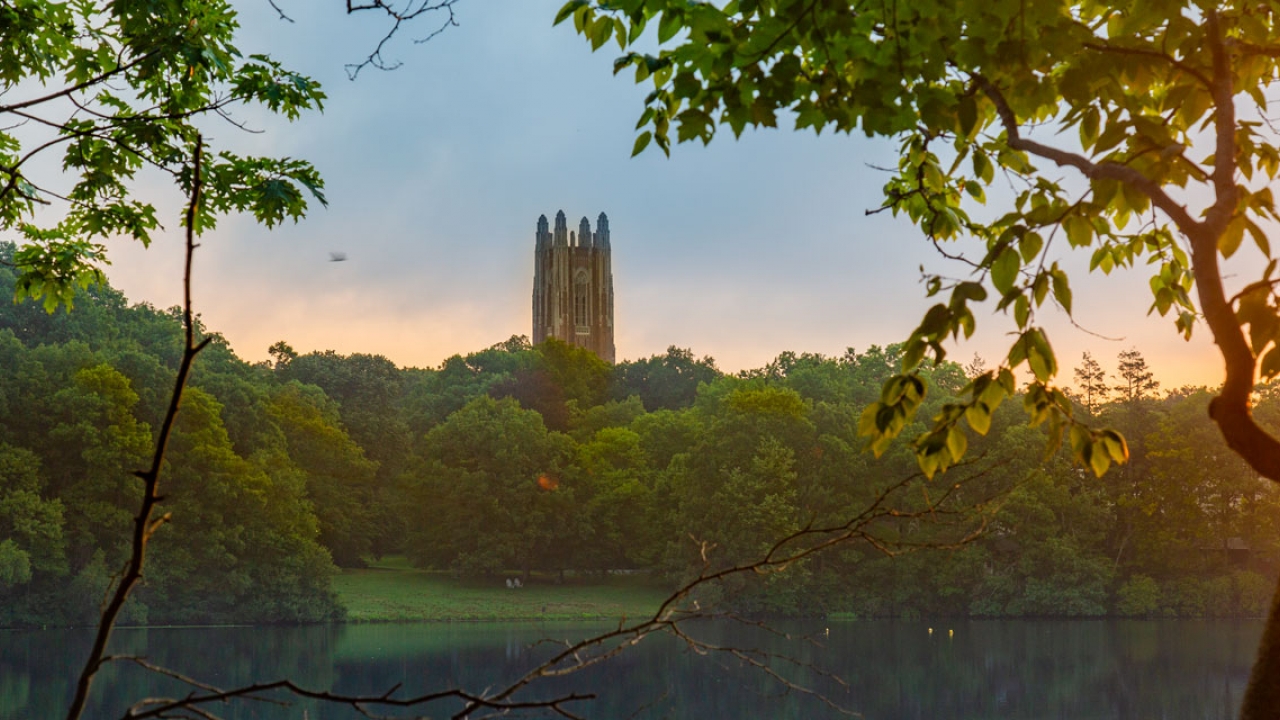 Dawn on Wellesley College's campus with Galen Stone Tower and Lake Waban in the background.