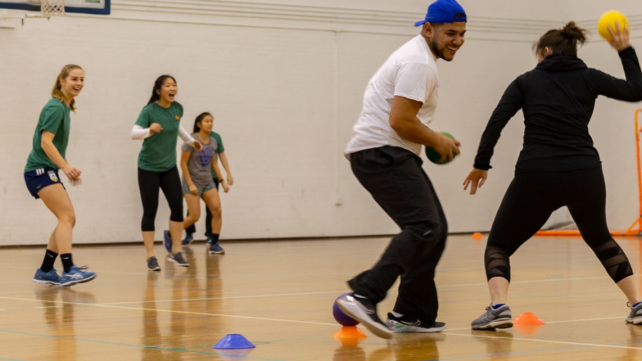 Student athletes and staff members play dodgeball.