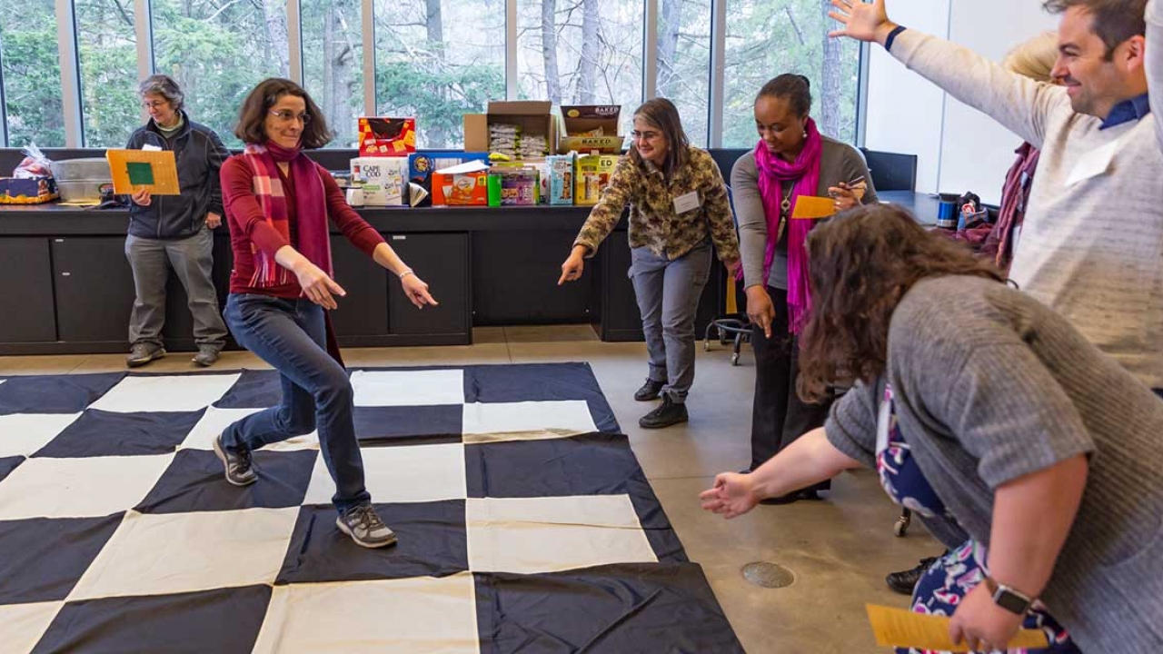 Faculty members participate in an activity during a retreat. 