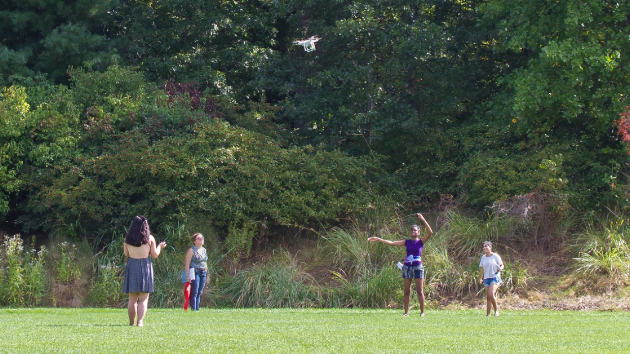 students directing a drone overhead