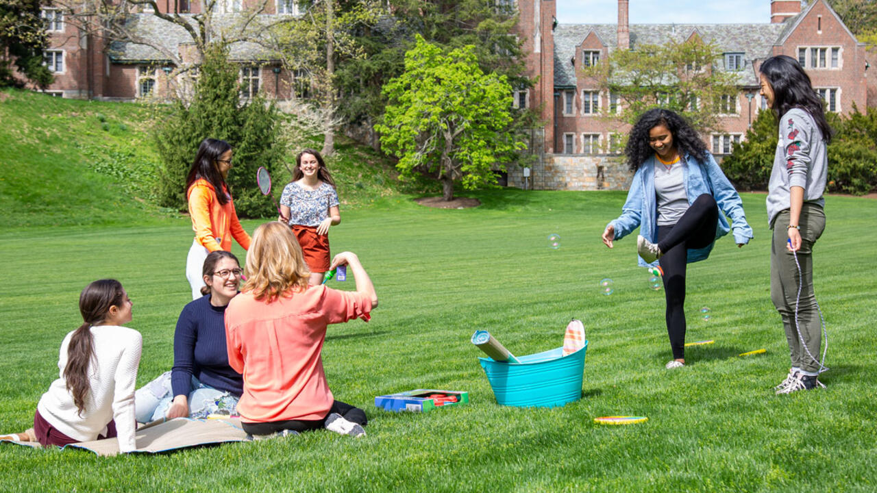 Students on Severance Green enjoy the outdoors in spring.