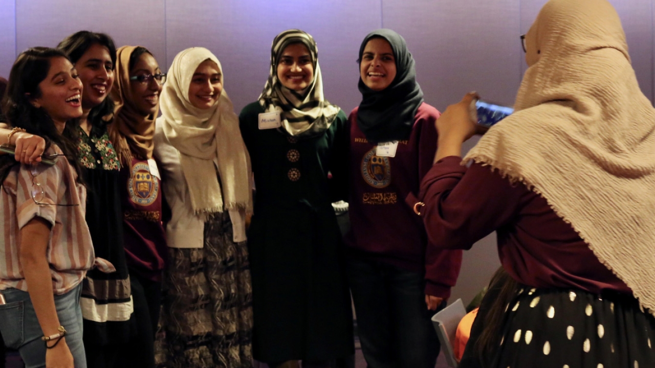 Students celebrate the 30th anniversary of Al-Muslimat by taking a photo after an event. 