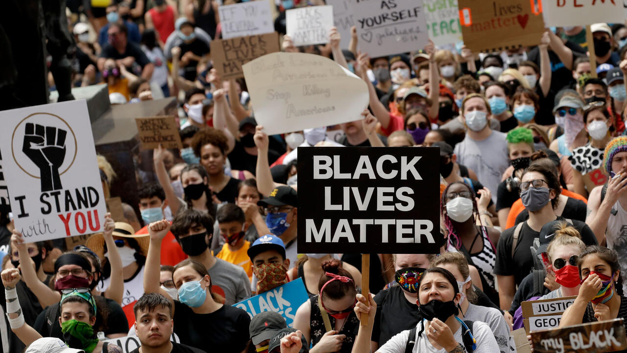 BLM protesters hold signs