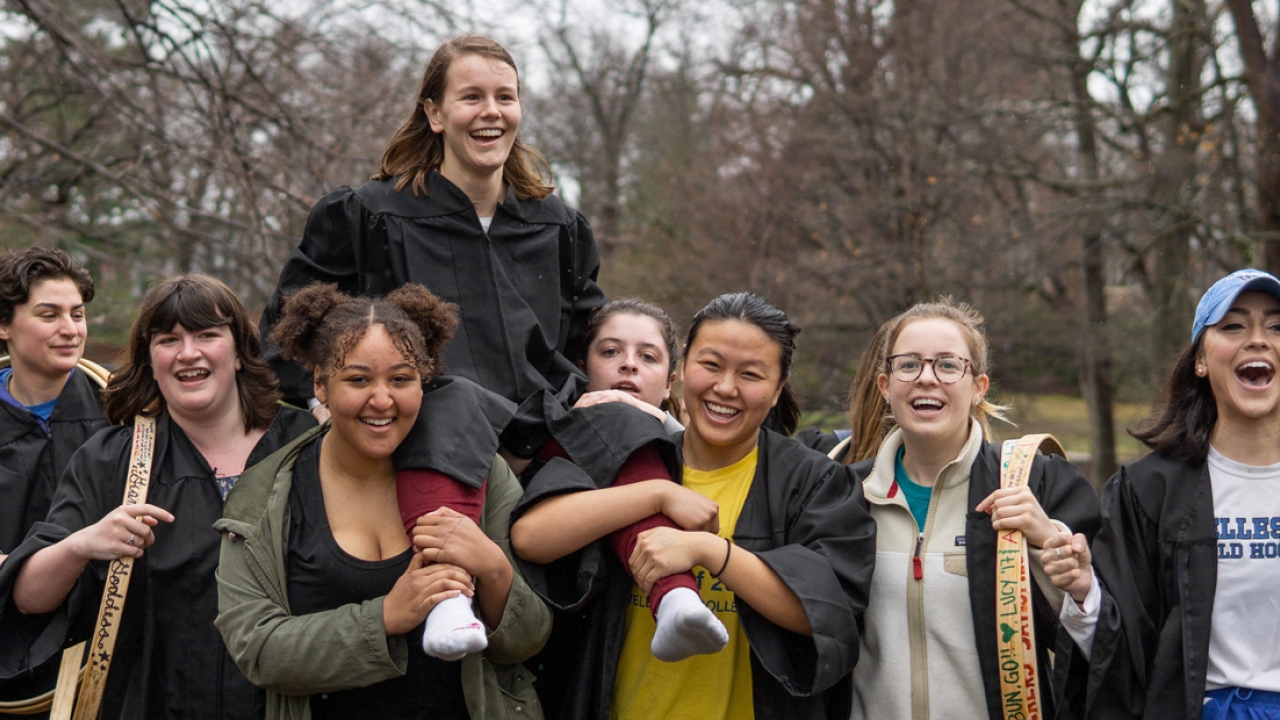 A Wellesley Senior is carried by her classmates after winning the hooprolling competition. 