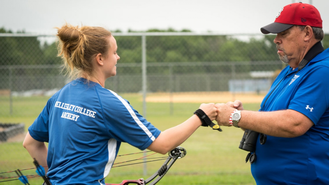 Karley Bussow ’18 and Wellesley archery coach E.G. LeBre prepare for the U.S. National Outdoor Collegiate Championships.