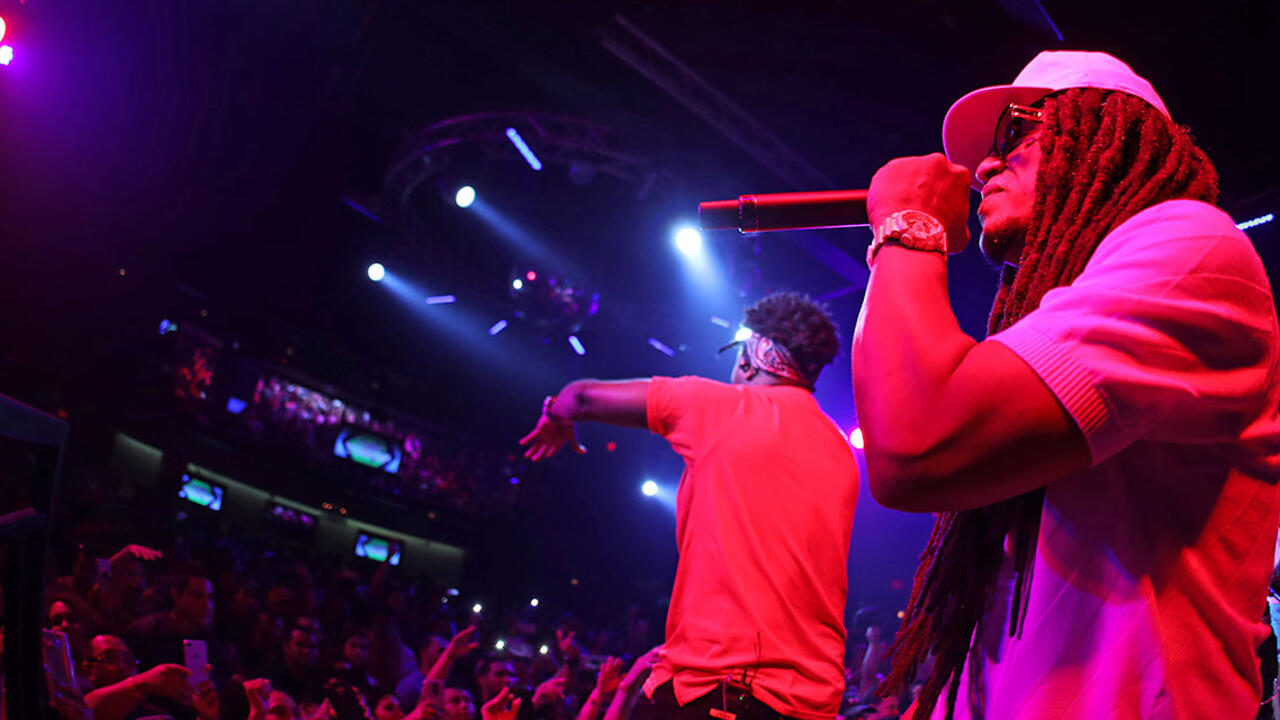 A male performer sings on stage.