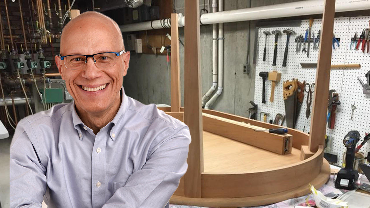 A composite photo with Professor Dan Sichel in the foreground and one of the tables he has made in the background.