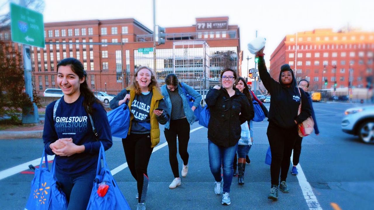 A group of students walk in a parking lot.