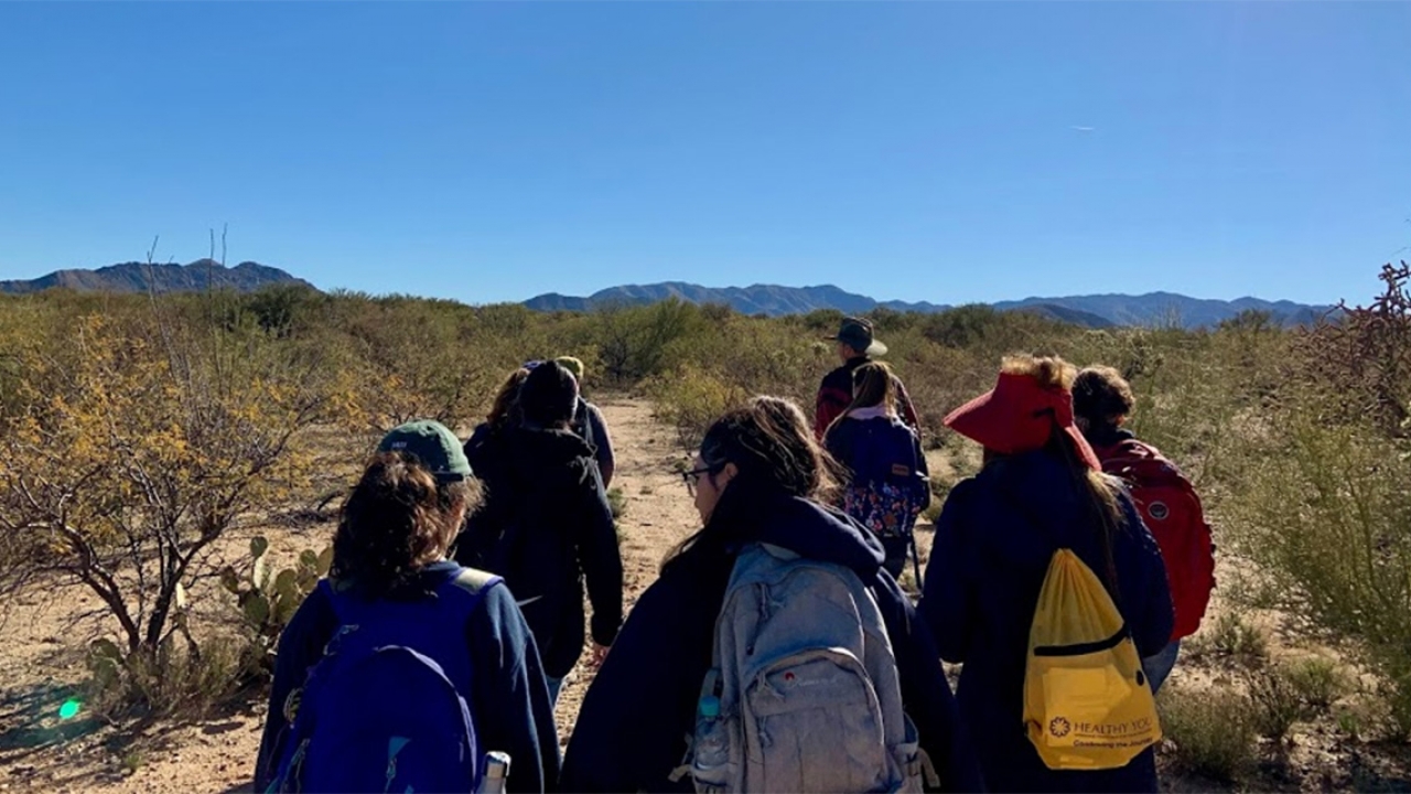 Students walk through a desert in Arizona.