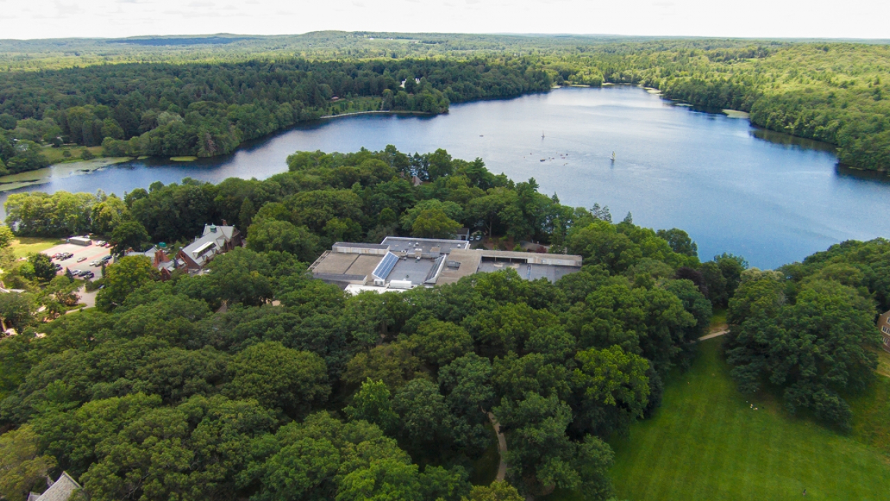 An ariel photo of campus with Lake Waban in the distance