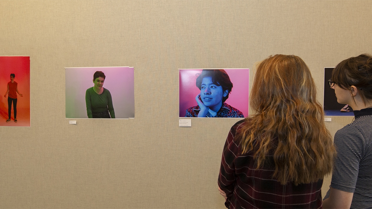 Two figures look at a photo exhibit