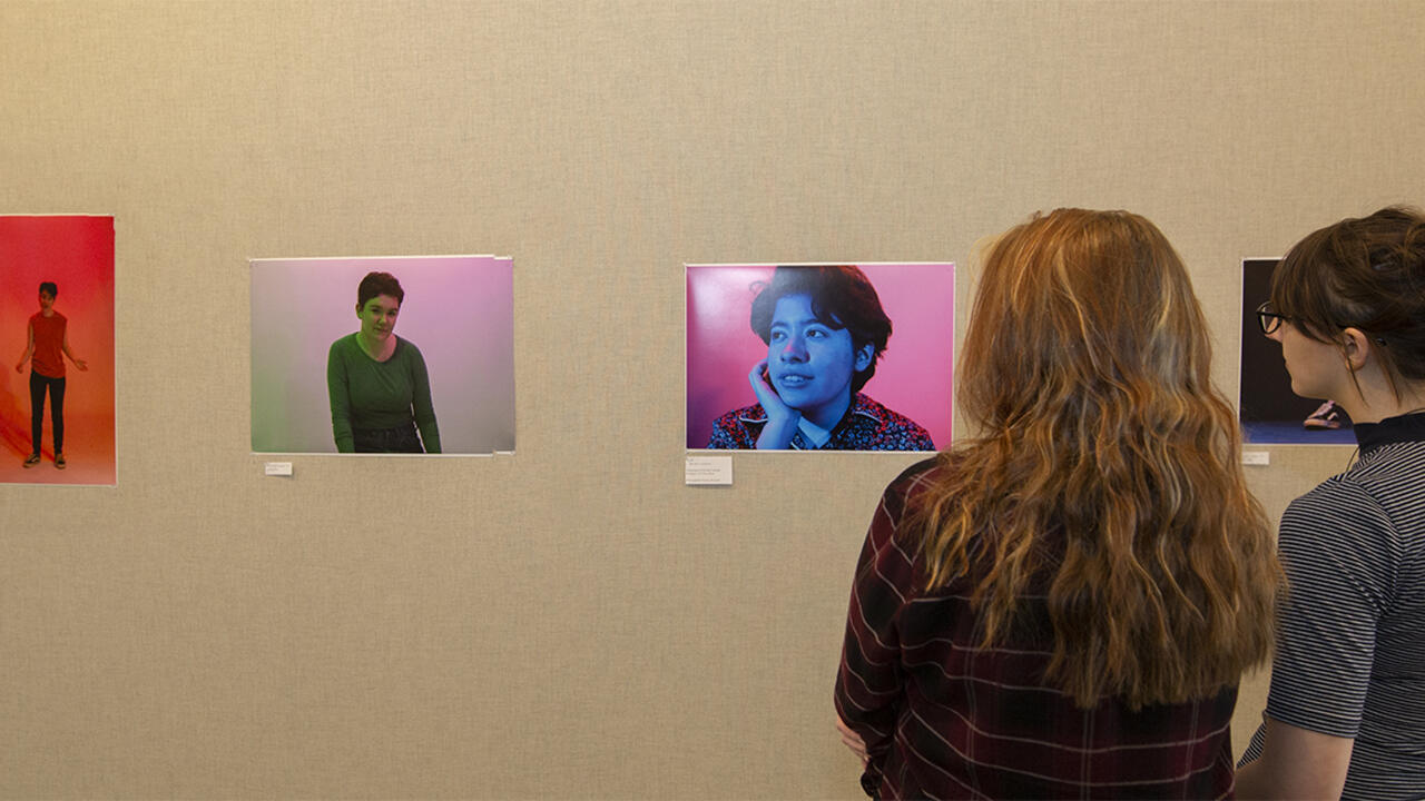 Two figures look at a photo exhibit