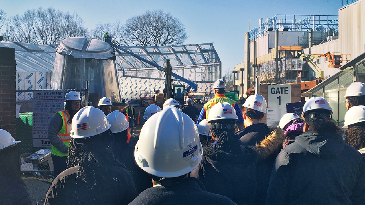 A group of young women take a tour of the science center construction project