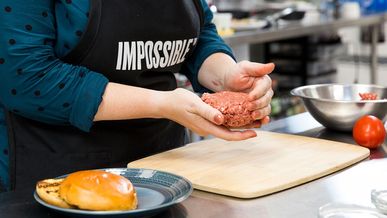 A woman creates a ball of "impossible burger."
