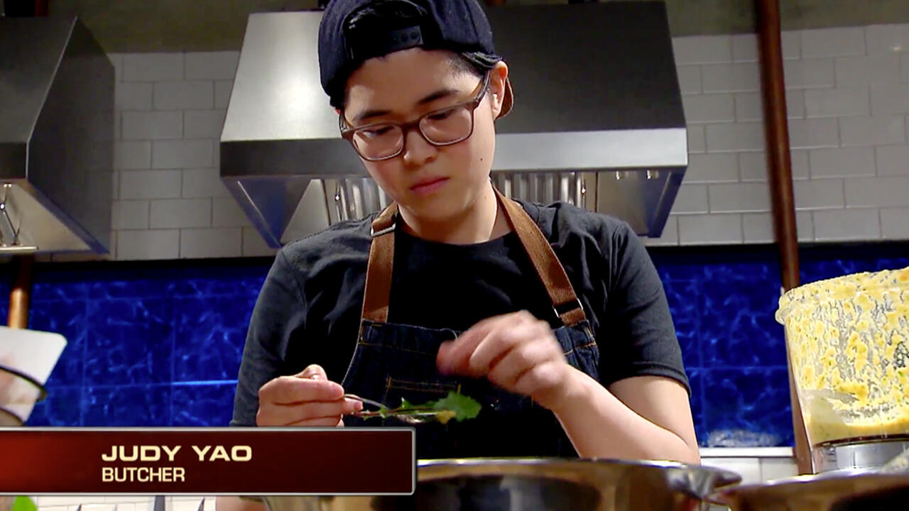 A woman works in a kitchen