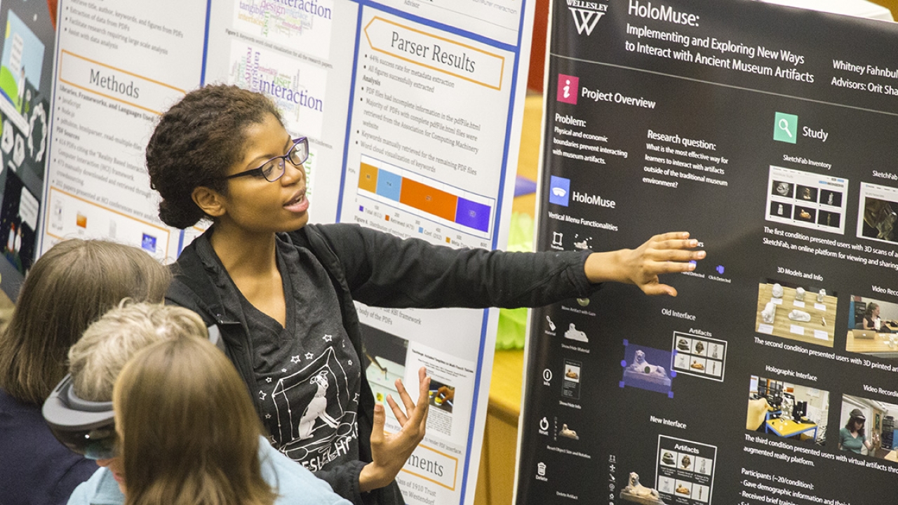 student presents a science poster session
