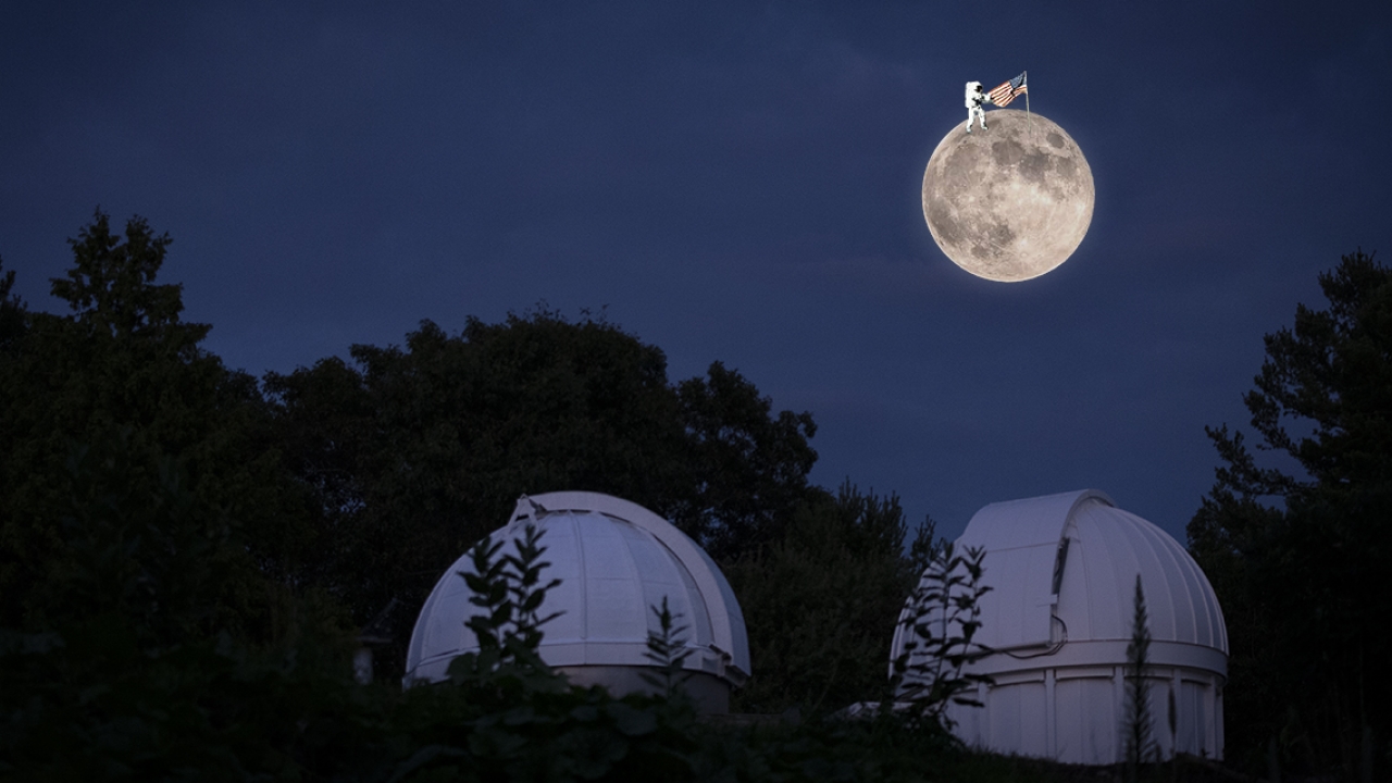 A large full moon with a tiny astronaut holding an American flag floats above the observatory. 