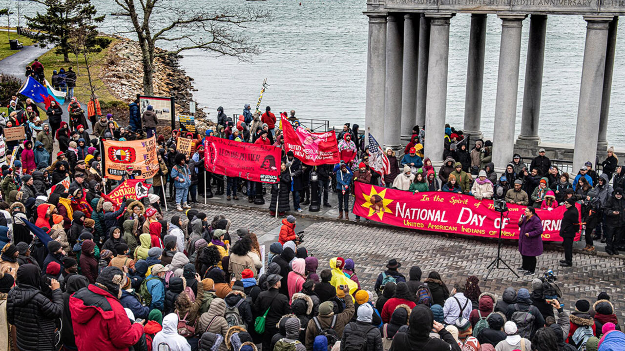 People attend a demonstration for National Day of Mourning along the water in Plymouth, MA.