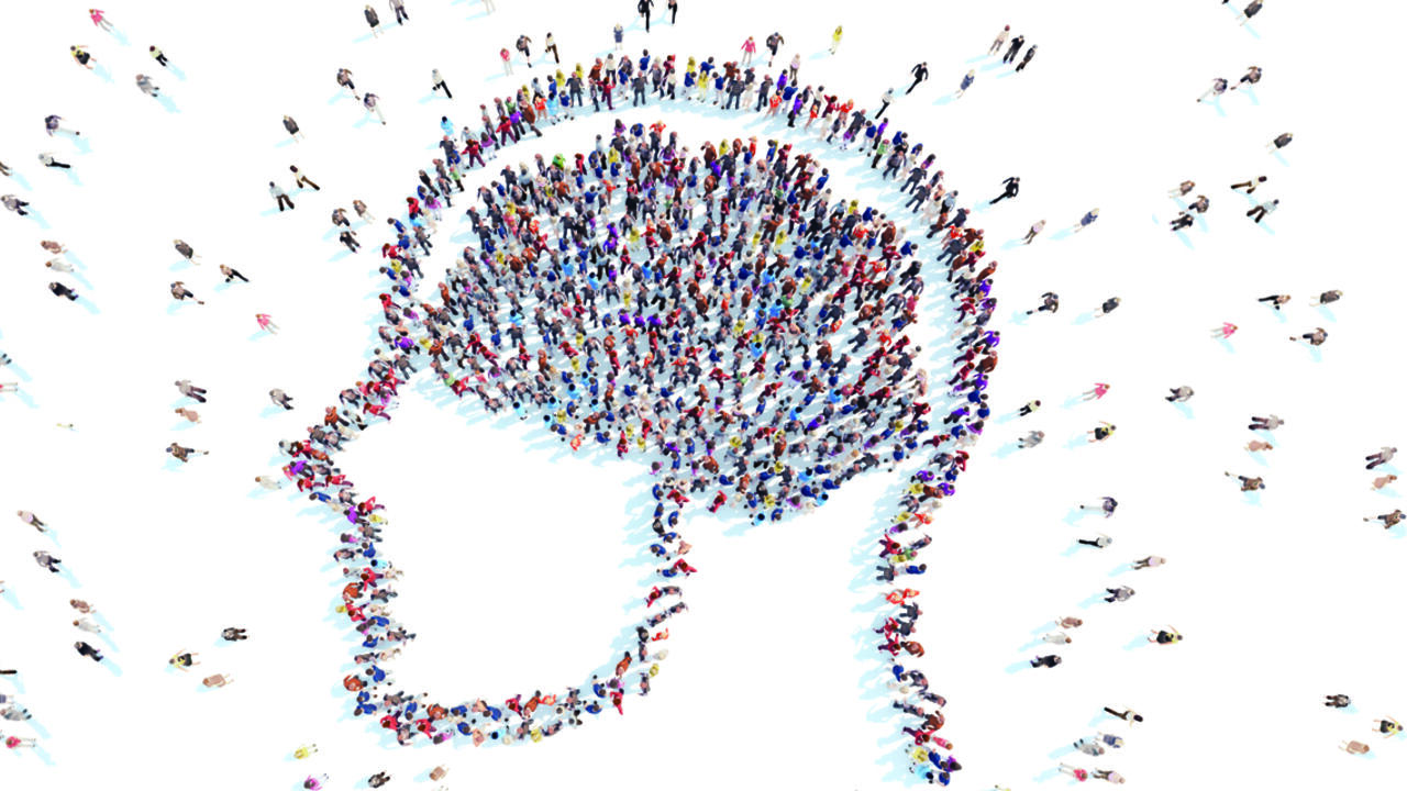 People standing in the shape of a human brain