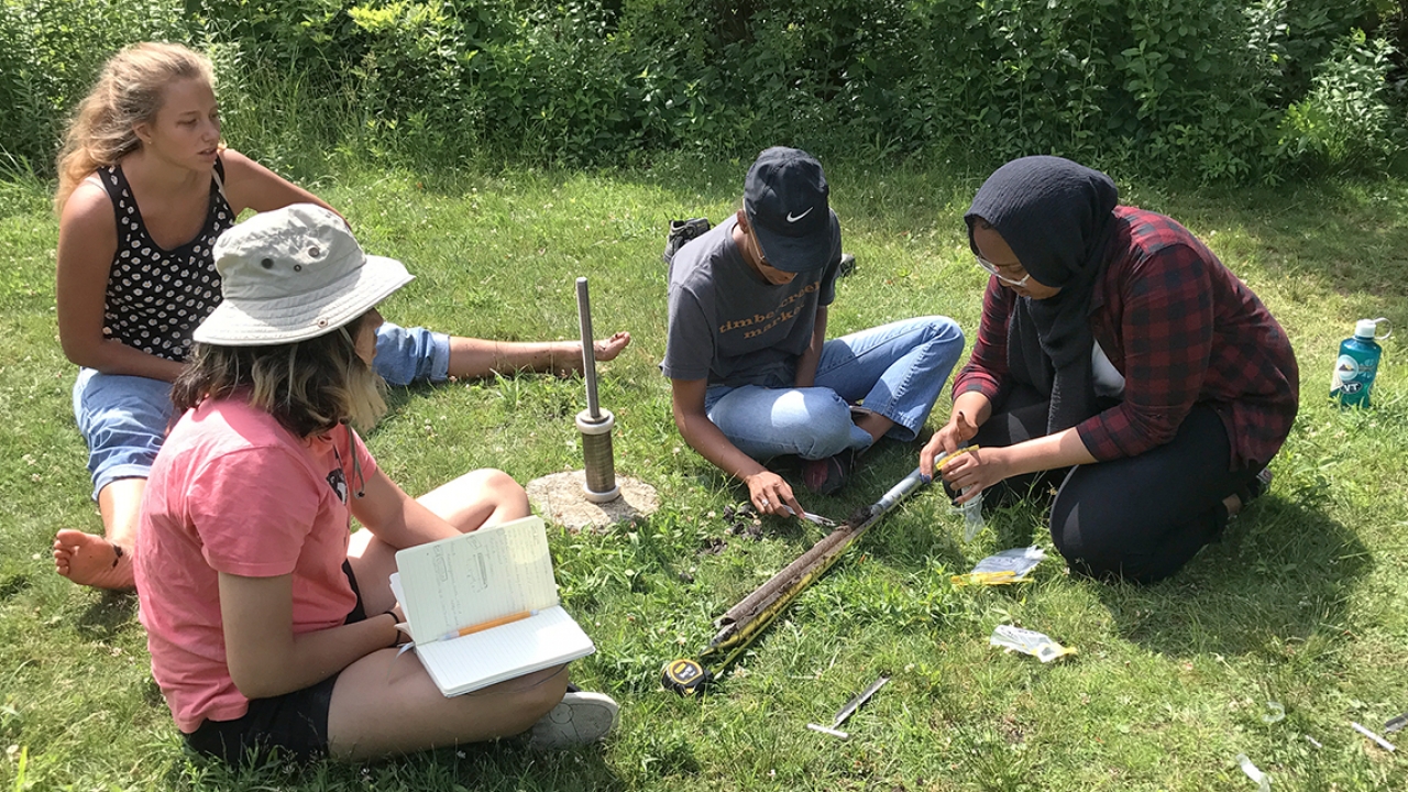 Students work on a project, collecting samples at Paramecium Pond
