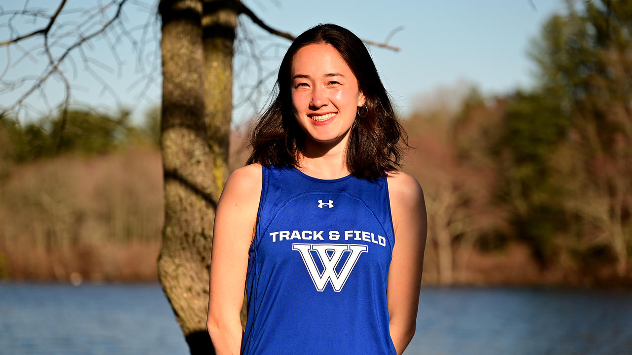 Ellie Murphy-Weise ’23 poses for a portrait in the late afternoon sun near Lake Waban.