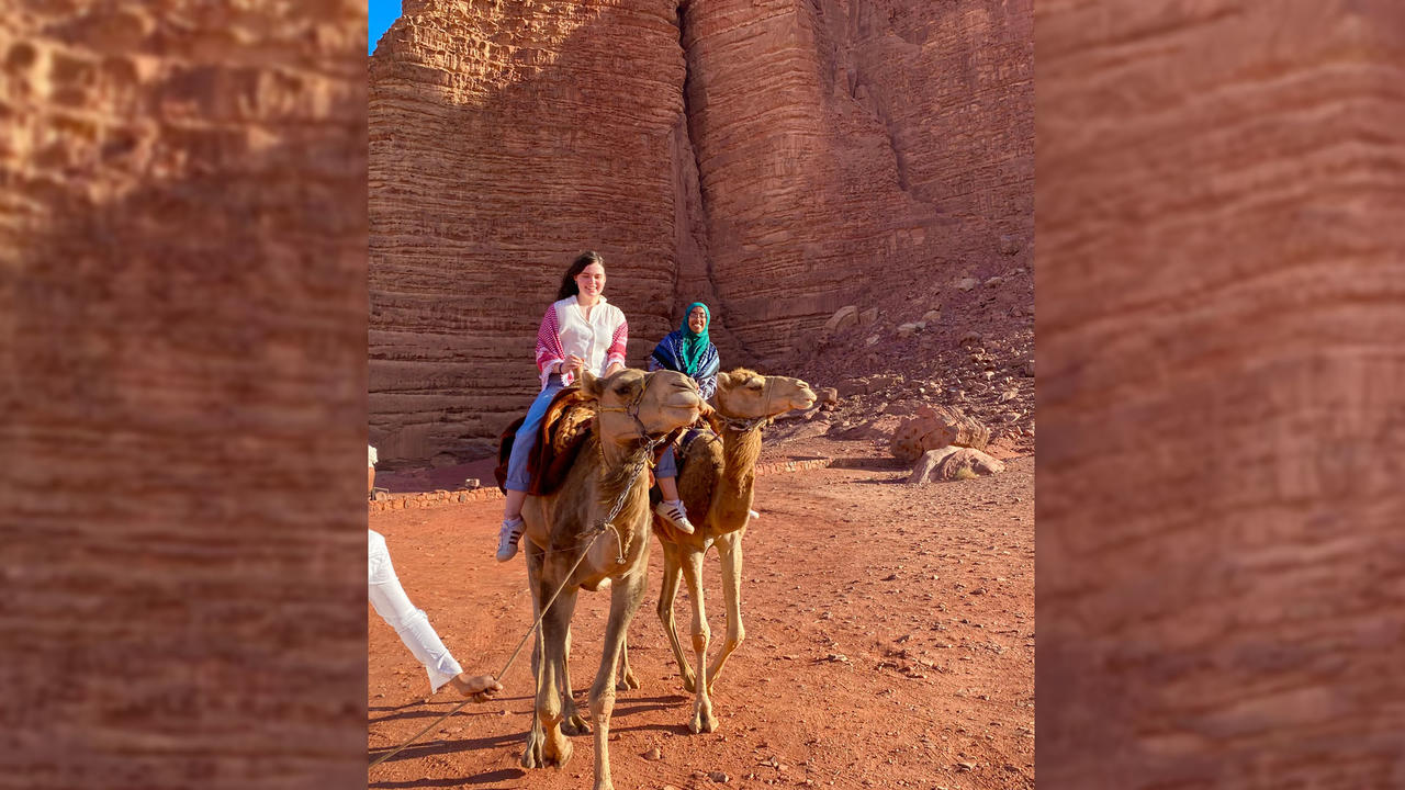 collage of students on camels in the desert of Jordan