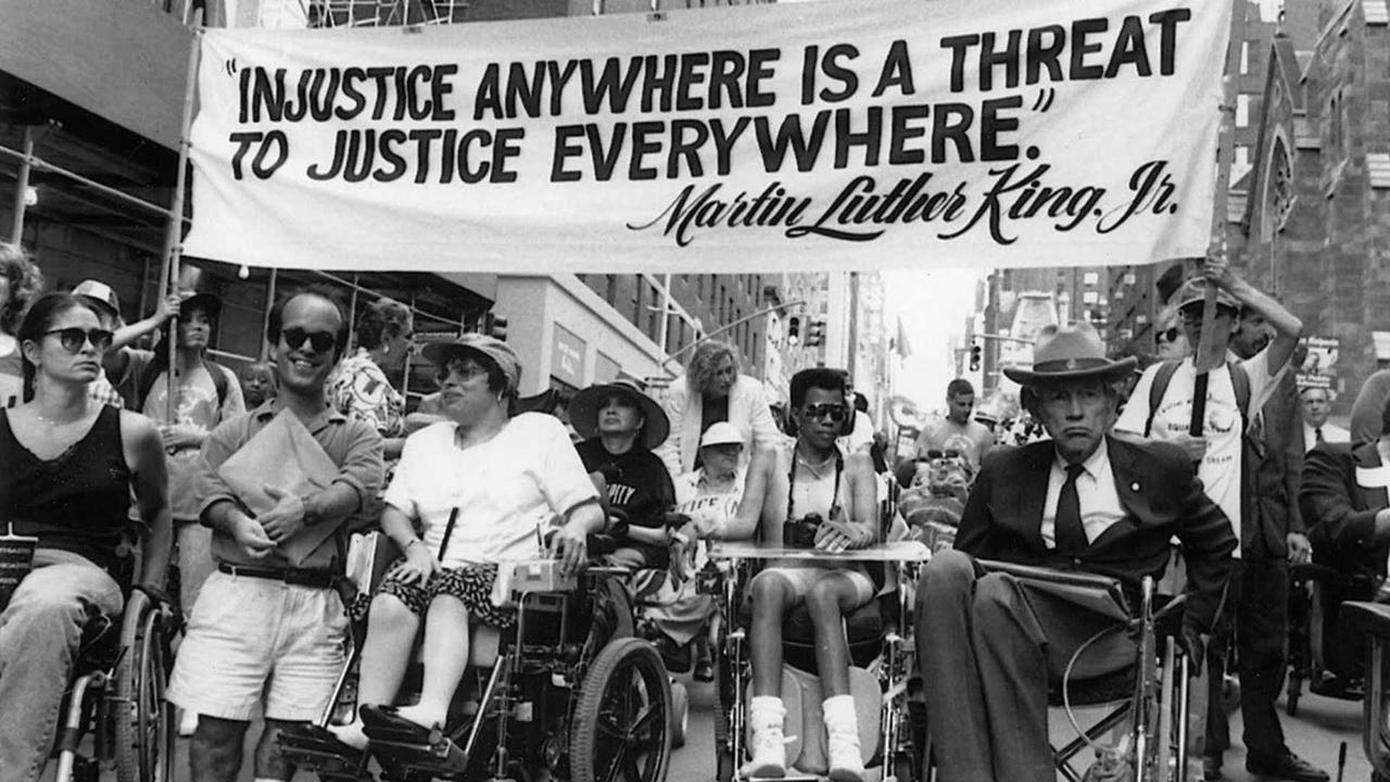 black and white photo of disability rights activists demonstrating