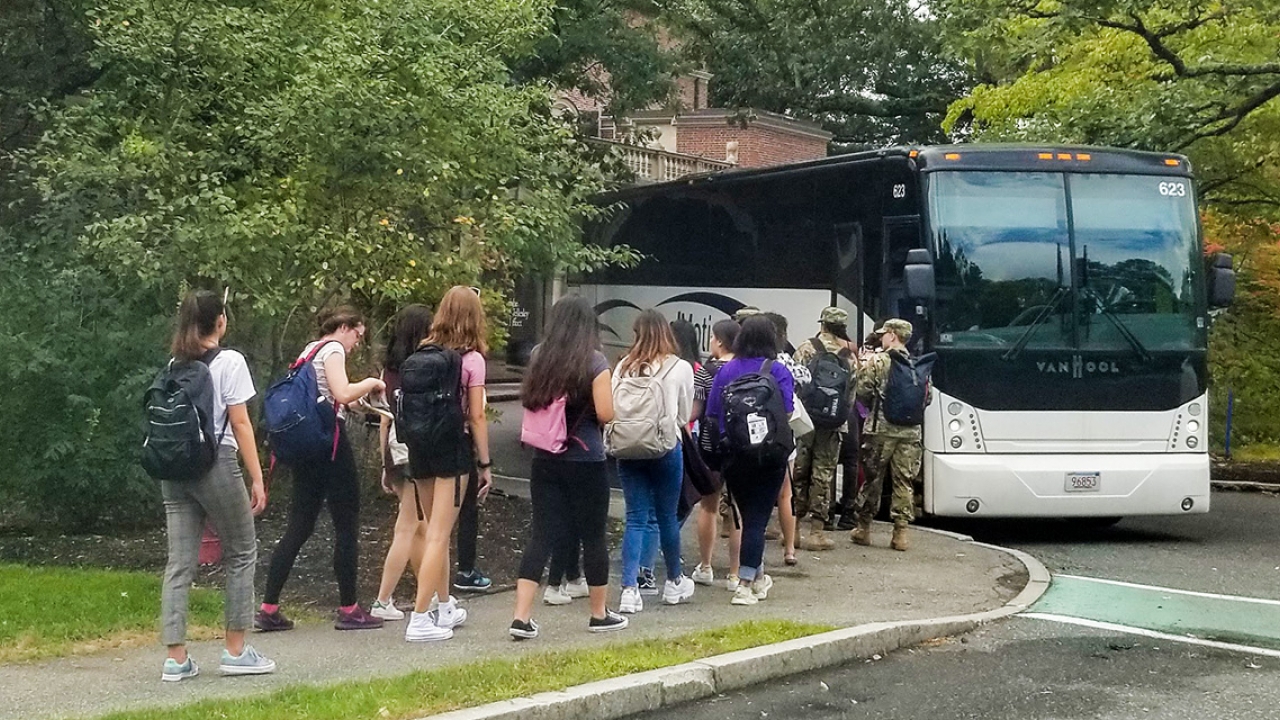 Students board a bus outside Lulu