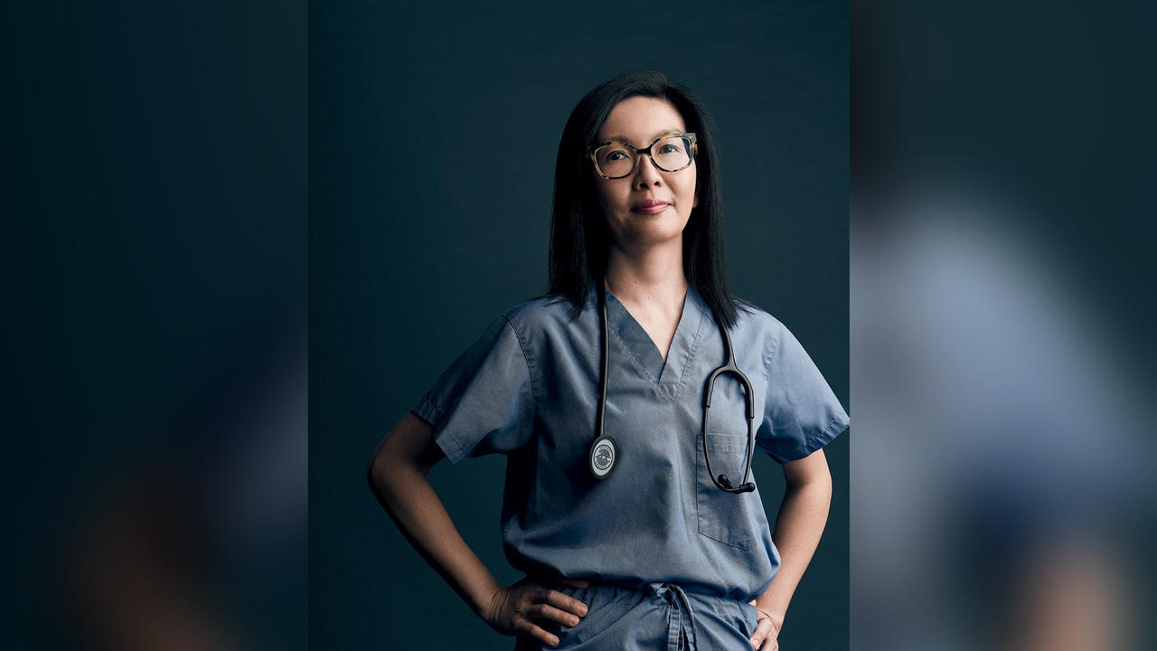 A portrait of Dr. Michelle Au ’99 in her scrubs and with a stethoscope around her neck.