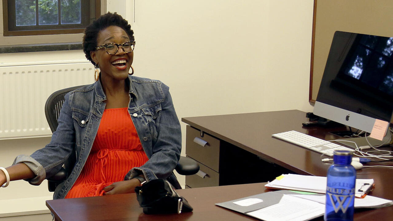 Nikki Green sitting at a desk and smiling