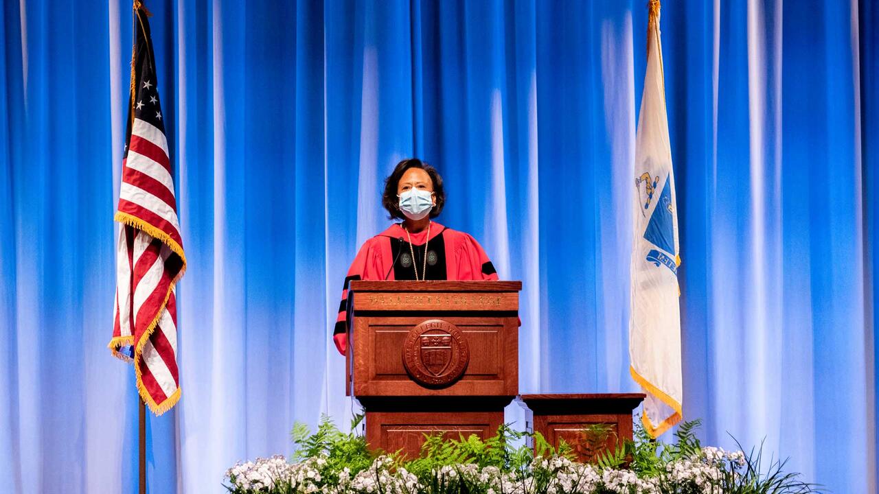 Paula Johnson speaking at podium