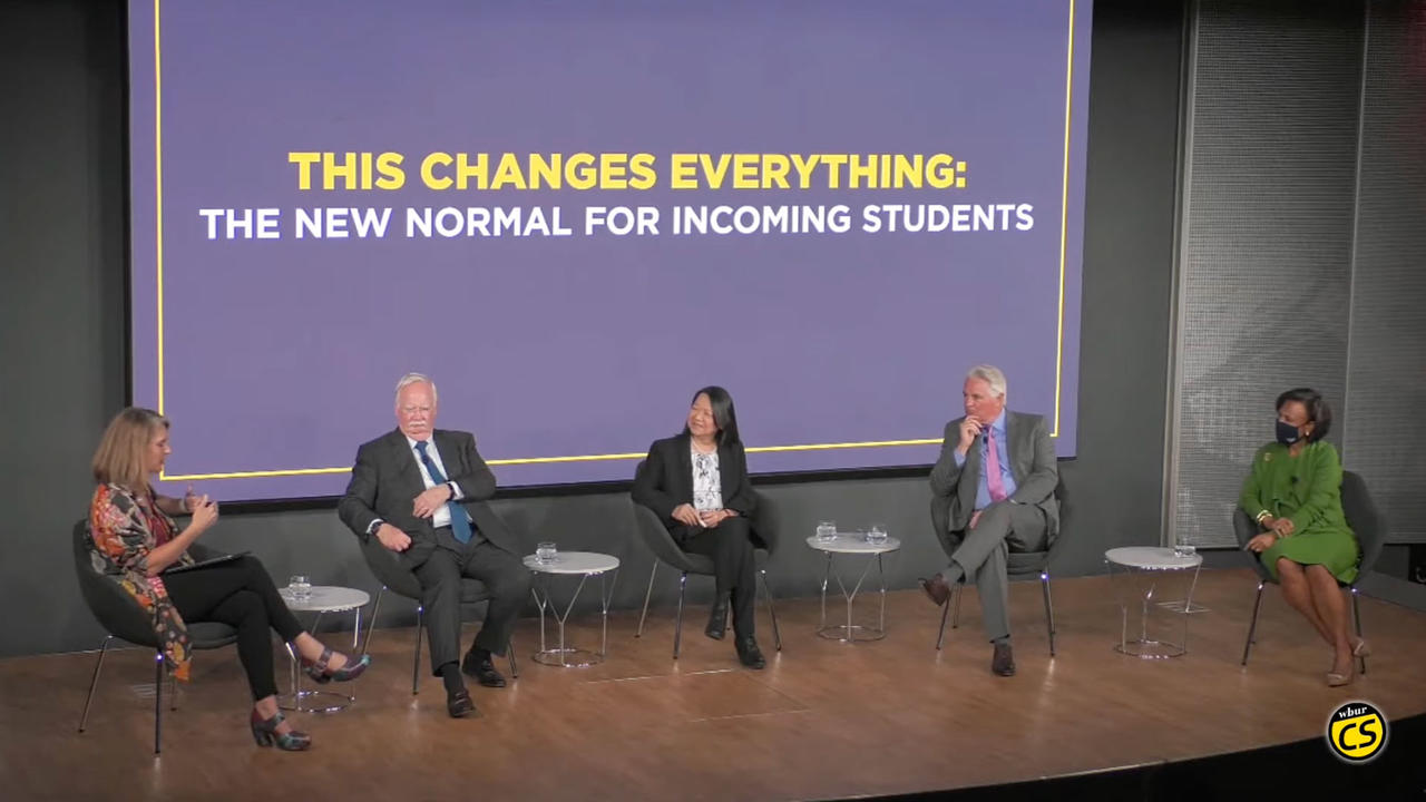 panelists sit on a stage