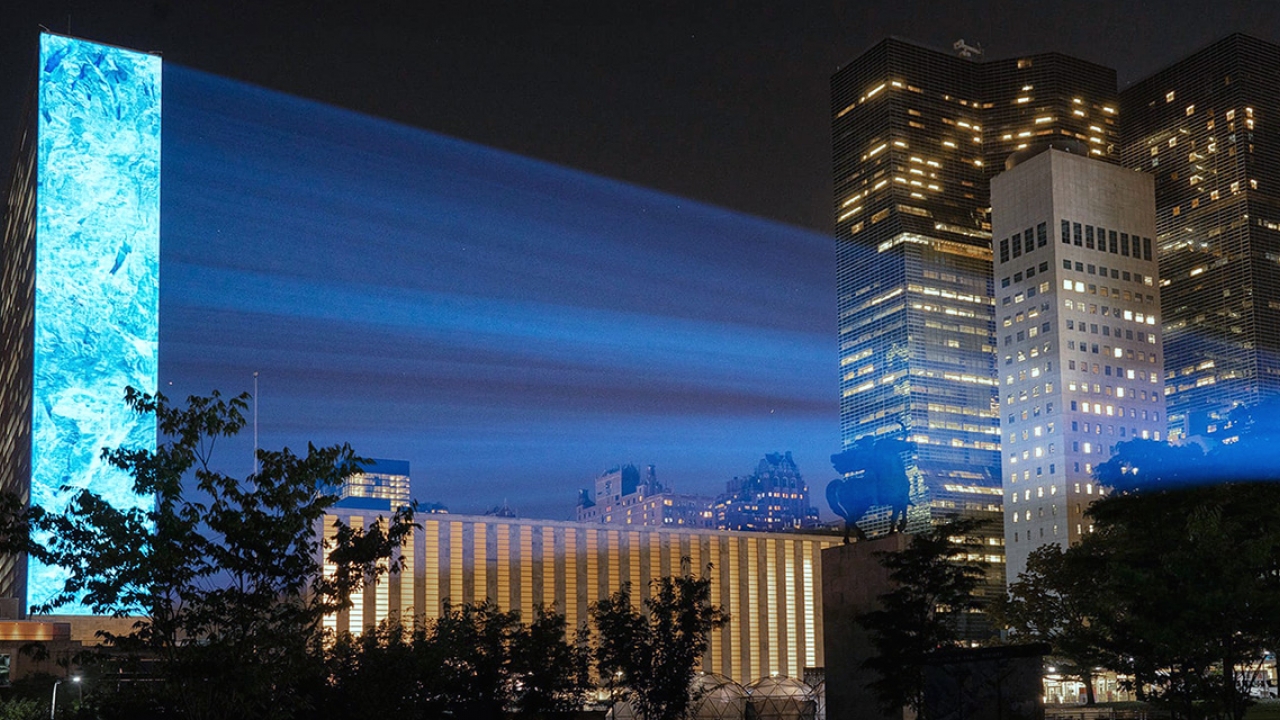 A photo of the UN building with light rays reflecting off it