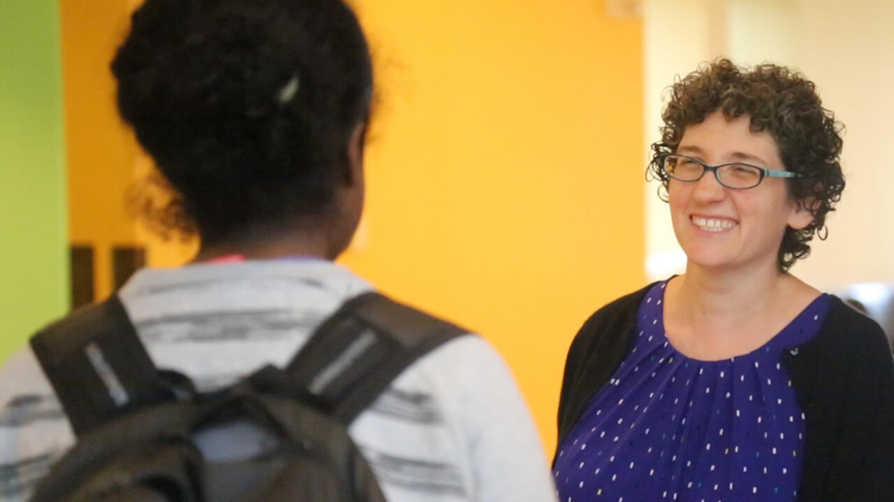 Rabbi Dena Bodian speaks to a student in Tischman Commons